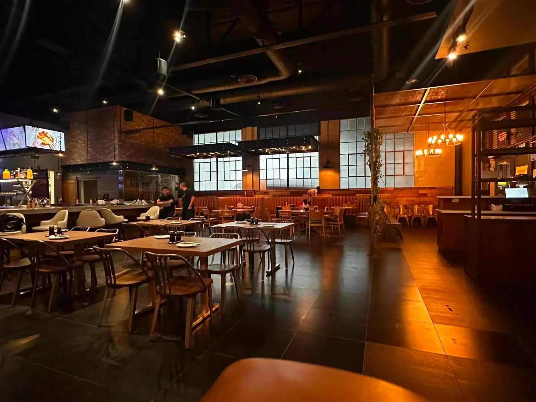 Well - lit dining area with brick walls and large windows at Dumpling King Asian Cuisine in Sacramento