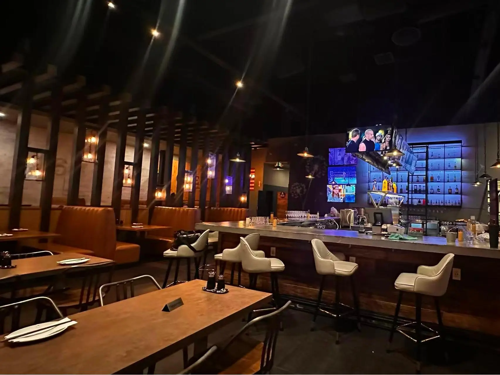Stylish bar area with stools and TV screens at Dumpling King Asian Cuisine in Sacramento