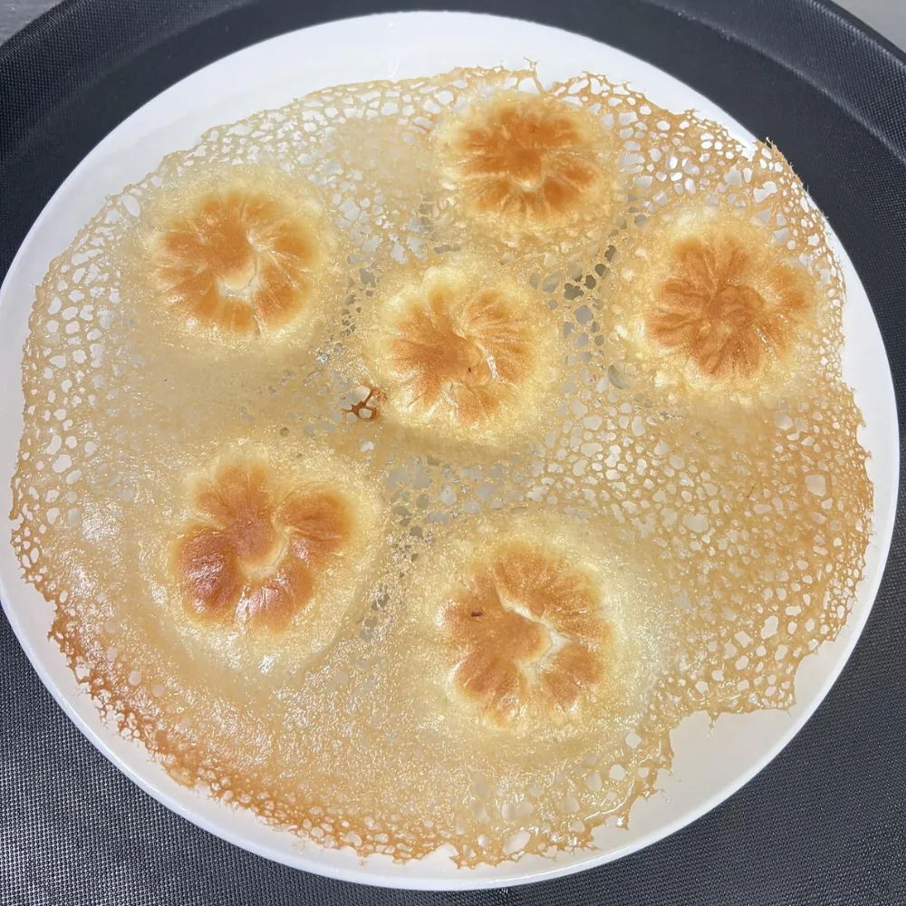 Potstickers with beautiful lacy crust served on a plate at Dumpling King Asian Cuisine in Sacramento